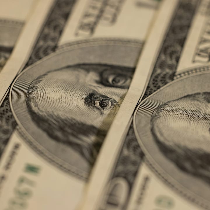 100$ dollar bills stacked on top of each other